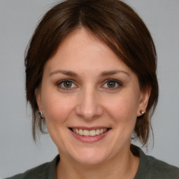 Joyful white adult female with medium  brown hair and brown eyes