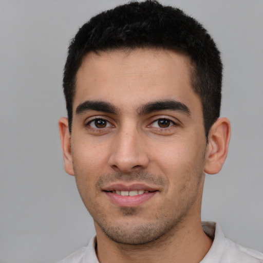 Joyful white young-adult male with short  black hair and brown eyes