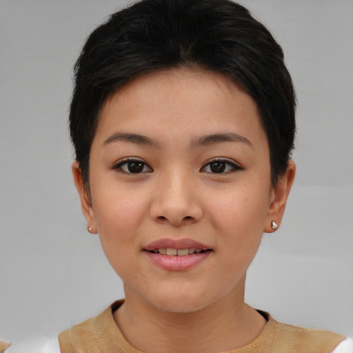 Joyful asian young-adult female with short  brown hair and brown eyes