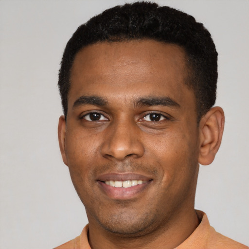 Joyful latino young-adult male with short  black hair and brown eyes