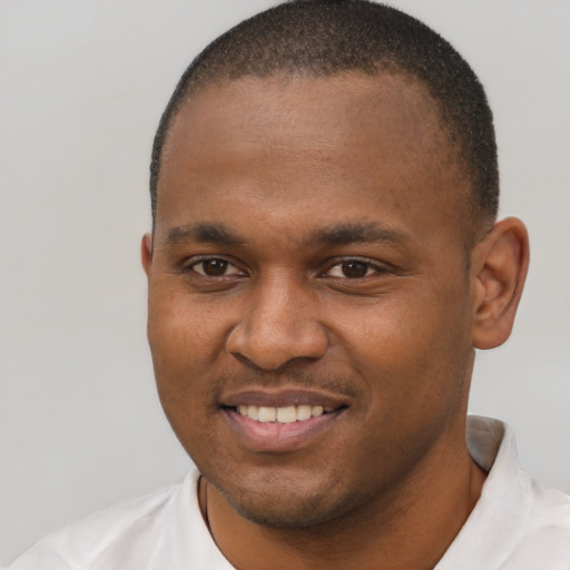 Joyful black young-adult male with short  brown hair and brown eyes
