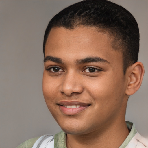 Joyful black young-adult male with short  brown hair and brown eyes