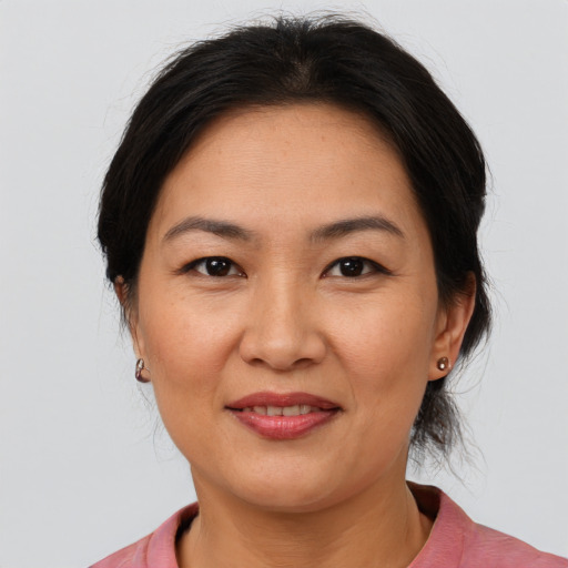 Joyful asian adult female with medium  brown hair and brown eyes