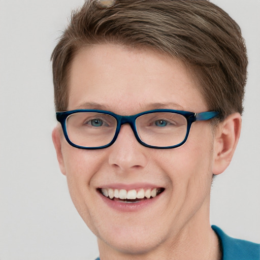 Joyful white young-adult male with short  brown hair and blue eyes