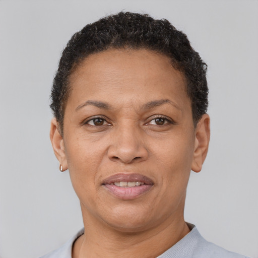 Joyful latino adult female with short  brown hair and brown eyes