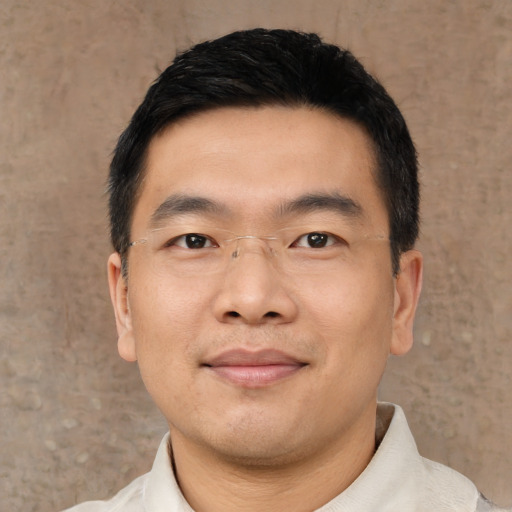 Joyful asian young-adult male with short  black hair and brown eyes