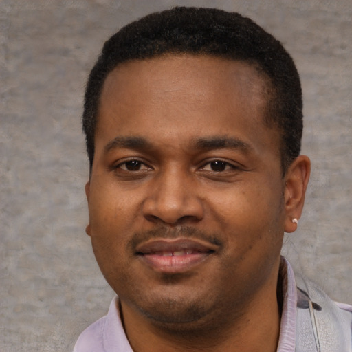 Joyful black young-adult male with short  brown hair and brown eyes
