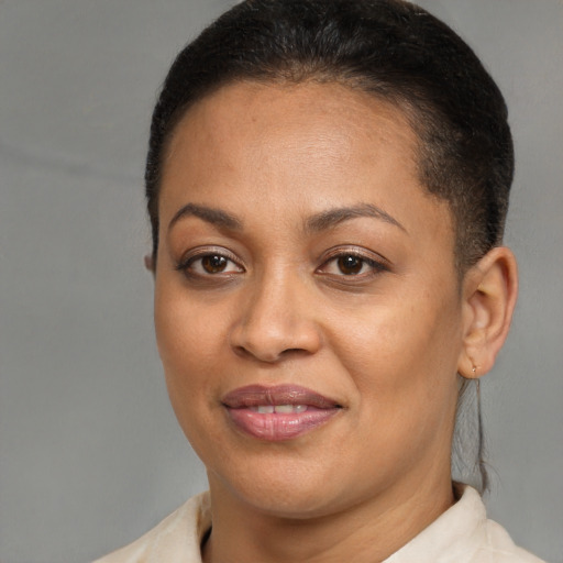 Joyful black young-adult female with short  brown hair and brown eyes