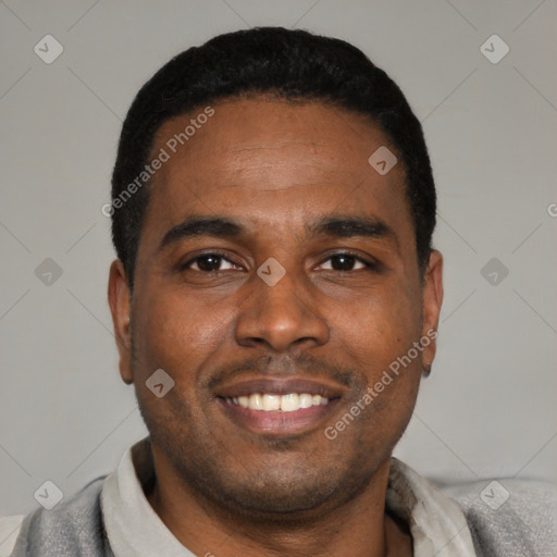 Joyful latino young-adult male with short  black hair and brown eyes