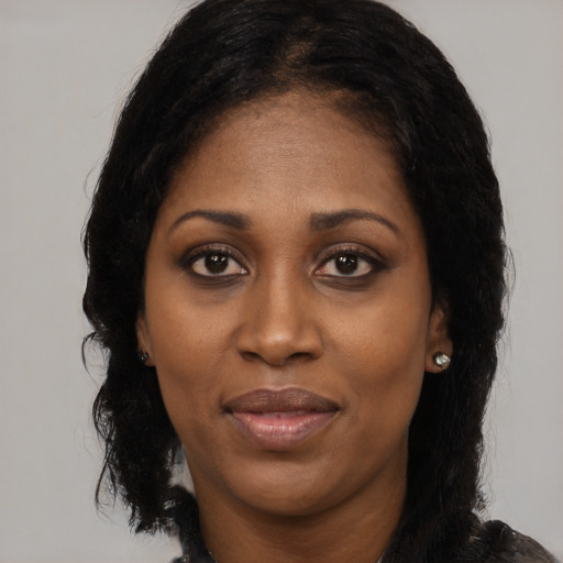 Joyful latino adult female with long  black hair and brown eyes