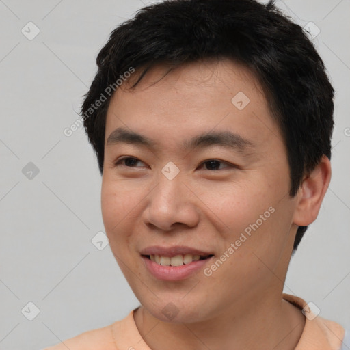 Joyful asian young-adult male with short  brown hair and brown eyes