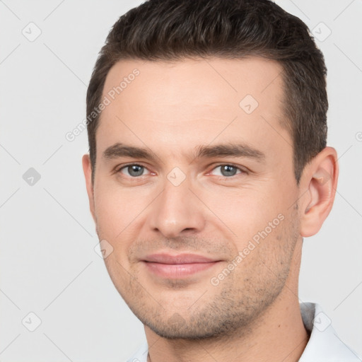 Joyful white young-adult male with short  brown hair and brown eyes