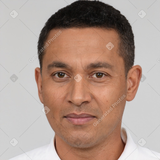 Joyful white adult male with short  black hair and brown eyes