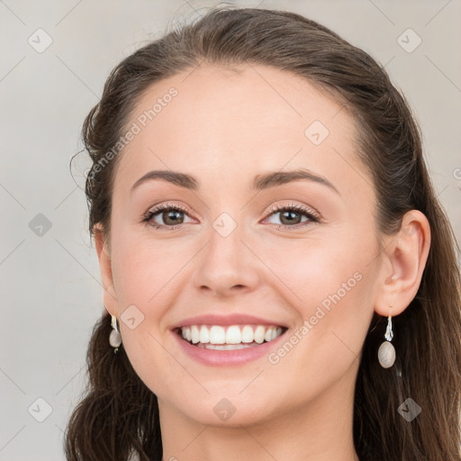 Joyful white young-adult female with long  brown hair and blue eyes