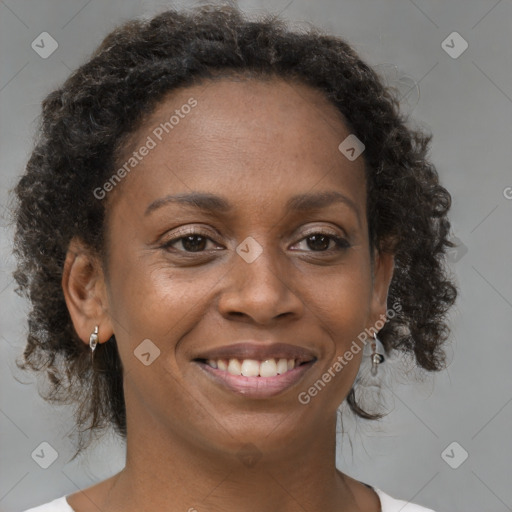 Joyful black young-adult female with medium  brown hair and brown eyes