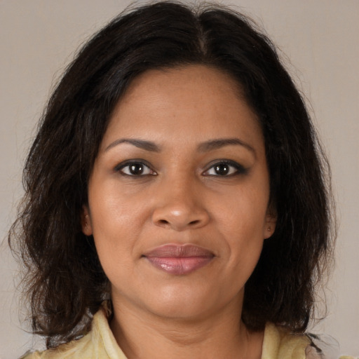 Joyful black adult female with medium  brown hair and brown eyes