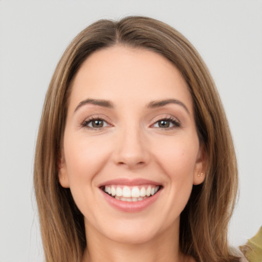 Joyful white young-adult female with long  brown hair and brown eyes