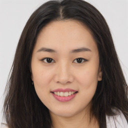 Joyful asian young-adult female with long  brown hair and brown eyes