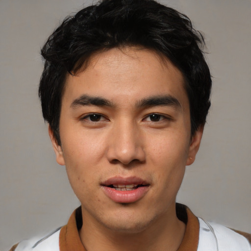 Joyful asian young-adult male with short  black hair and brown eyes