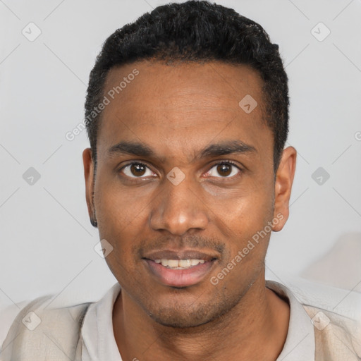 Joyful black young-adult male with short  black hair and brown eyes