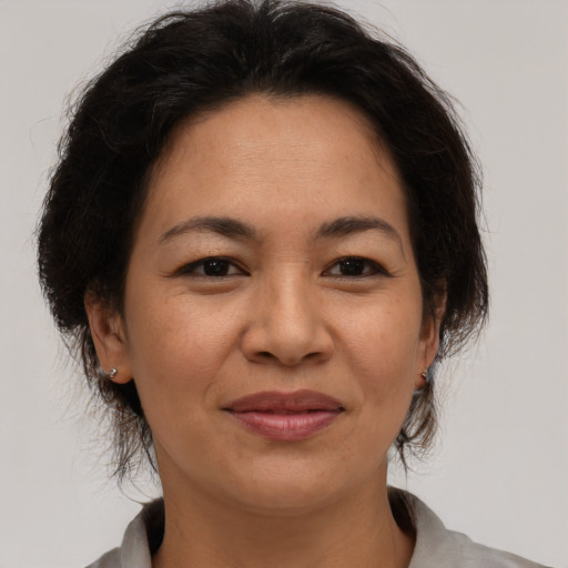 Joyful asian adult female with medium  brown hair and brown eyes