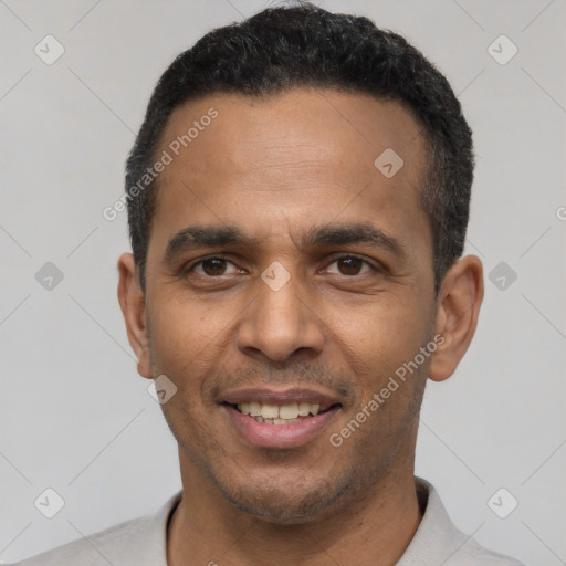 Joyful latino young-adult male with short  black hair and brown eyes