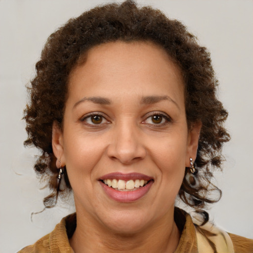 Joyful latino adult female with medium  brown hair and brown eyes