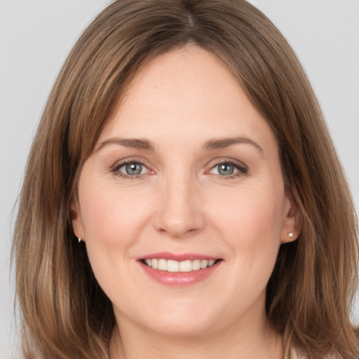 Joyful white young-adult female with long  brown hair and grey eyes