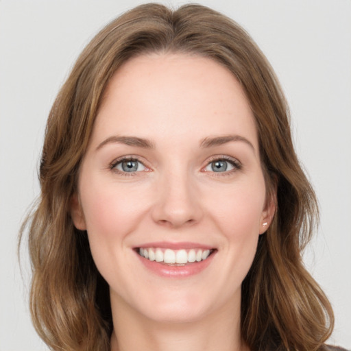 Joyful white young-adult female with medium  brown hair and green eyes