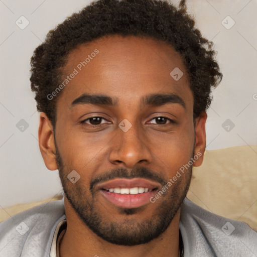 Joyful black young-adult male with short  brown hair and brown eyes