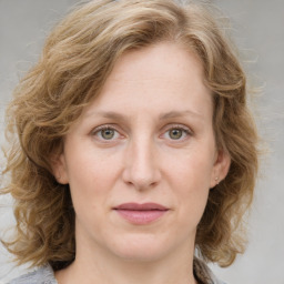 Joyful white young-adult female with medium  brown hair and blue eyes