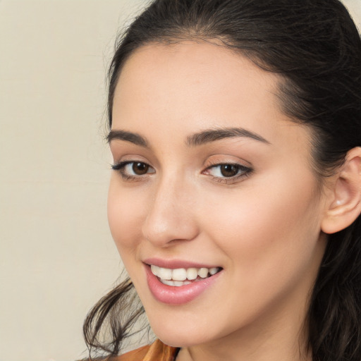 Joyful white young-adult female with long  brown hair and brown eyes