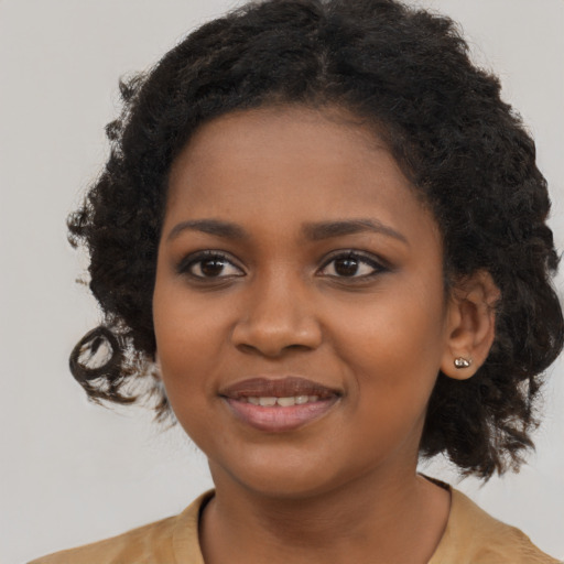 Joyful black young-adult female with medium  brown hair and brown eyes