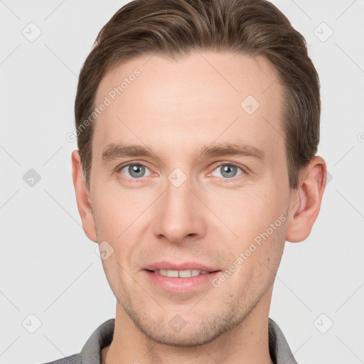 Joyful white young-adult male with short  brown hair and grey eyes