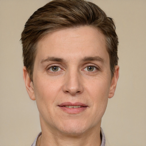 Joyful white adult male with short  brown hair and grey eyes