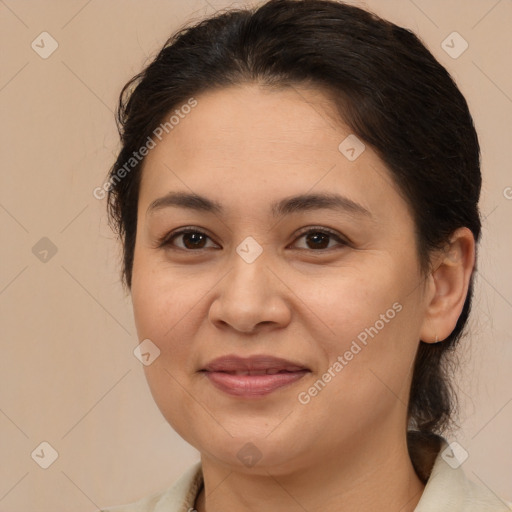 Joyful latino adult female with medium  brown hair and brown eyes