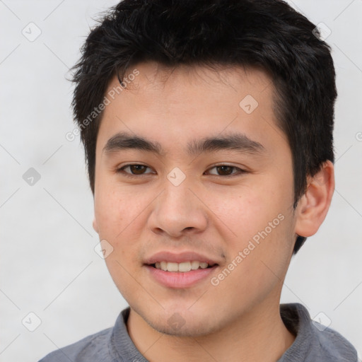 Joyful asian young-adult male with short  brown hair and brown eyes