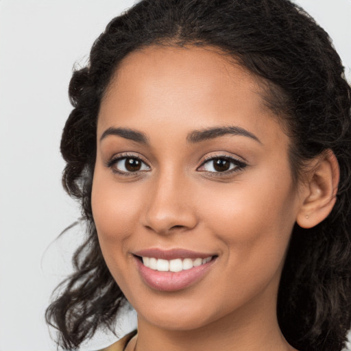 Joyful latino young-adult female with long  brown hair and brown eyes