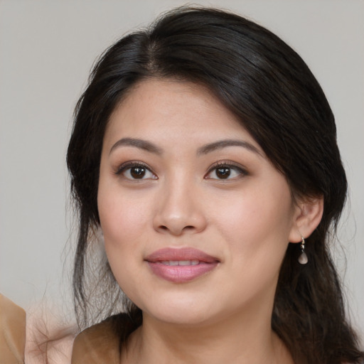 Joyful asian young-adult female with medium  brown hair and brown eyes