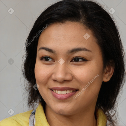 Joyful latino young-adult female with long  brown hair and brown eyes