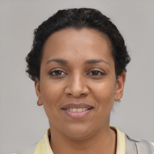 Joyful latino young-adult female with short  black hair and brown eyes
