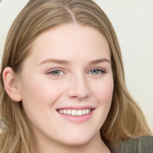 Joyful white young-adult female with long  brown hair and blue eyes