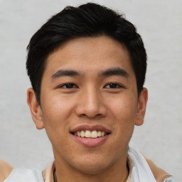 Joyful asian young-adult male with short  black hair and brown eyes