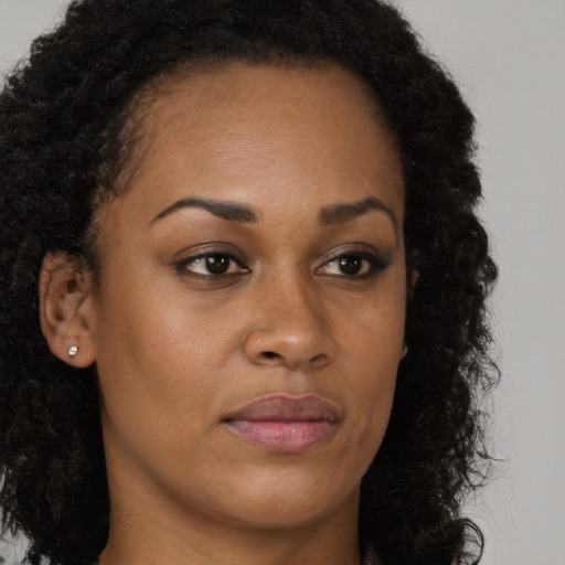 Neutral black young-adult female with long  brown hair and brown eyes