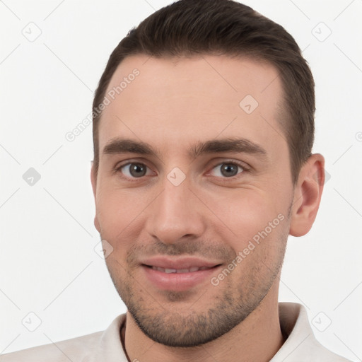 Joyful white young-adult male with short  brown hair and brown eyes