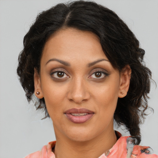 Joyful black adult female with medium  brown hair and brown eyes