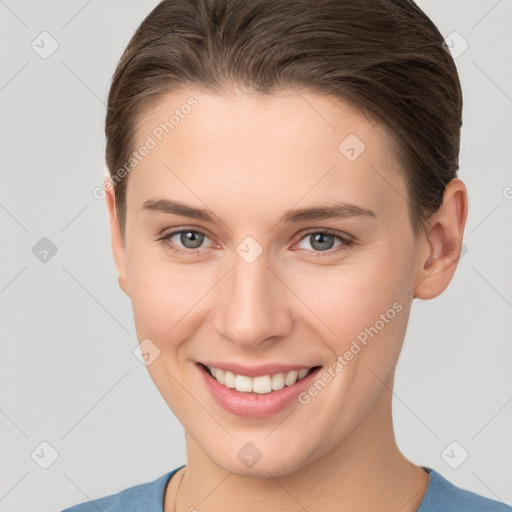 Joyful white young-adult female with short  brown hair and brown eyes