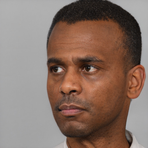 Neutral black adult male with short  black hair and brown eyes