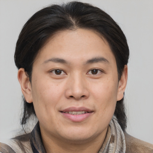 Joyful white adult female with medium  brown hair and brown eyes