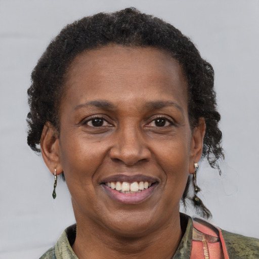 Joyful black adult female with short  brown hair and brown eyes